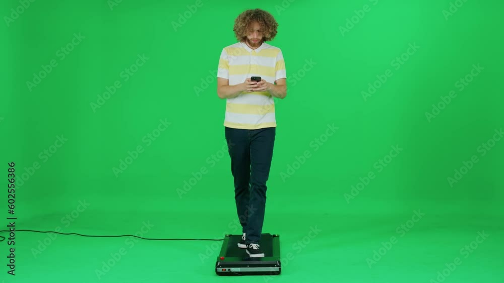 Passer-by man walking on a green background and uses a smartphone, man enjoy a walk and works on the go, template on a chromakey. Passer-by man walking on a green background and uses a smartphone, man enjoy a walk and works on the go, template on a chromakey.