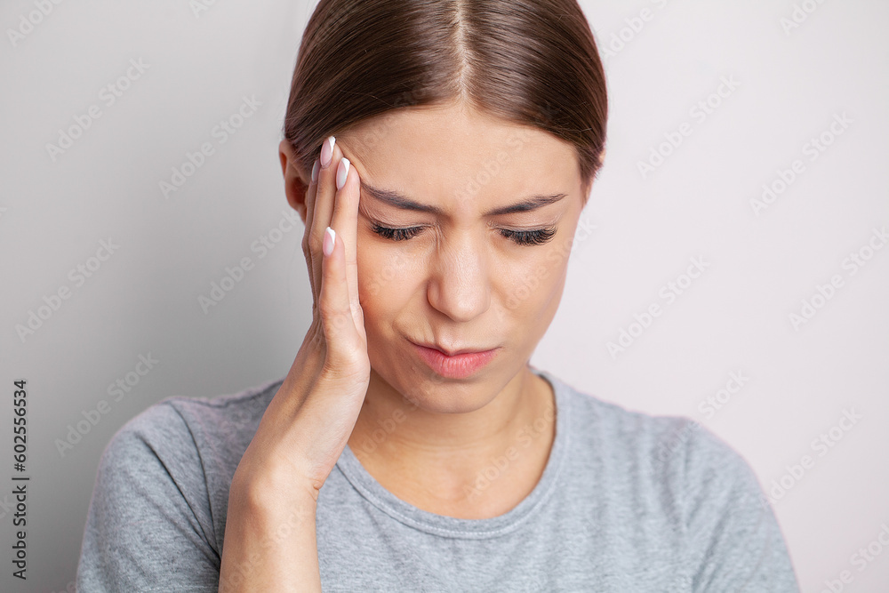 Feeling strong headache massaging temples exhausted from overwork, fatigued overwhelmed lady. Feeling strong headache massaging temples exhausted from overwork, fatigued overwhelmed lady.