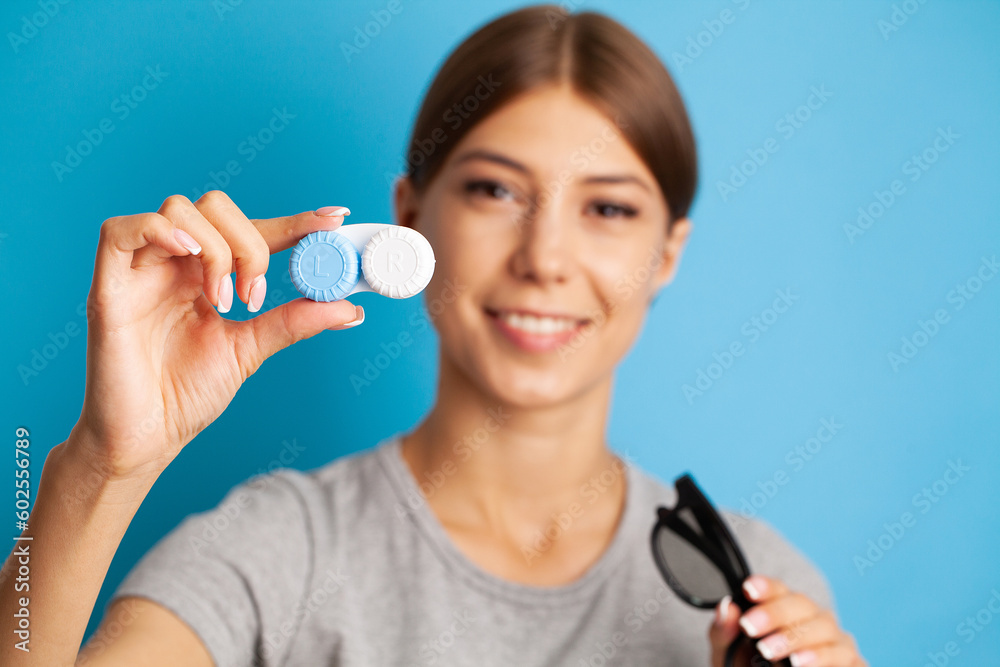 Smiling woman with contact eye lenses and container in hand Smiling woman with contact eye lenses and container in hand