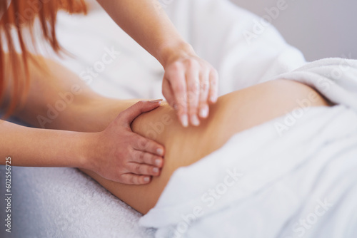 Woman having thigh and buttocks massage in salon