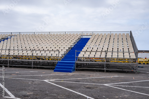 bleachers installed on the esplanade of a public parking lot for an open-air concert. Blue and white plastic seats. Puerto de la Cruz  Tenerife  Canary Islands  Spain