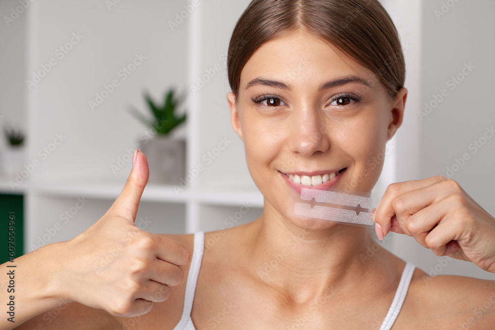 Teeth Whitening, Beautiful Smiling Woman Holding Whitening Strip. Teeth Whitening, Beautiful Smiling Woman Holding Whitening Strip.