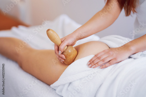 Woman at massage therapy with wooden tools