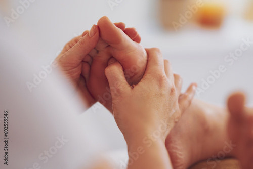 Woman having foot reflexology massage in salon