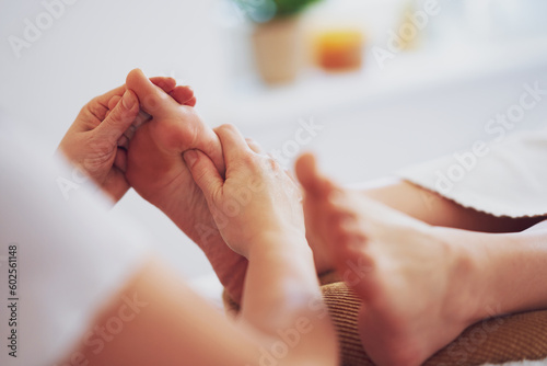 Woman having foot reflexology massage in salon photo