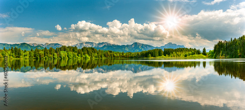 Fototapeta Naklejka Na Ścianę i Meble -  panoramic landscape in region Allgäu at springtime with beautiful lake and alps mountain range in backround