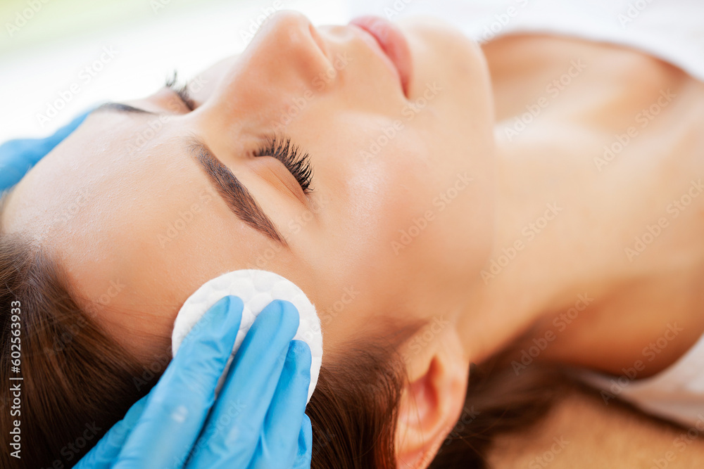 Beautiful girl has a facial massage in a beauty clinic.