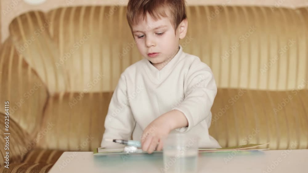 Child boy draws with a water marker Child boy draws with a water marker