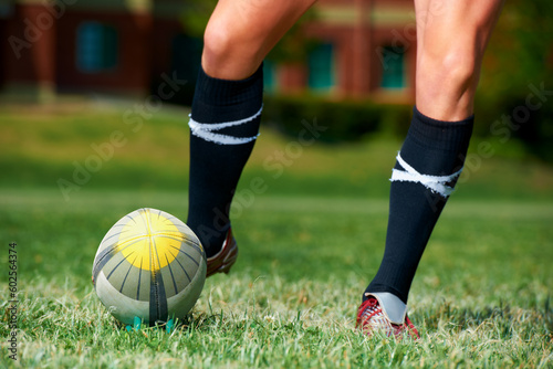 Rugby, feet and man with a sports ball outdoor on a pitch for action, goal or score. Male athlete person playing in sport competition, game or start training for fitness, workout or kick exercise