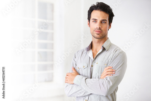 Portrait, man and real estate agent with arms crossed, pride for career or job with mockup. Face, serious and male realtor, entrepreneur and confident professional from Spain standing in home.