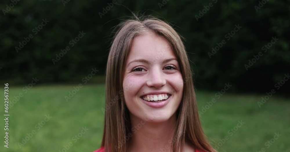 Young happy girl smiling on camera outdoor Young happy girl smiling on camera outdoor