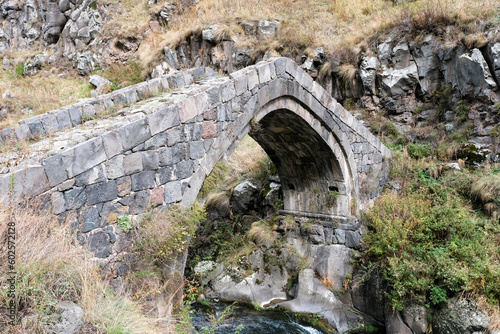 Medieval bridge across Urut river on cloudy autumn day. Loriberd fortres, Lori Province, Armenia. photo