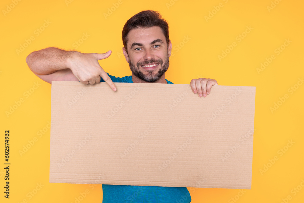 Happy man holding empty board and pointing finger on board. Guy showing blank board with copyspace. Idea and offer. Your advertisement. Blank advertising board with empty space for text, mockup. Happy man holding empty board and pointing finger on board. Guy showing blank board with copyspace. Idea and offer. Your advertisement. Blank advertising board with empty space for text, mockup.