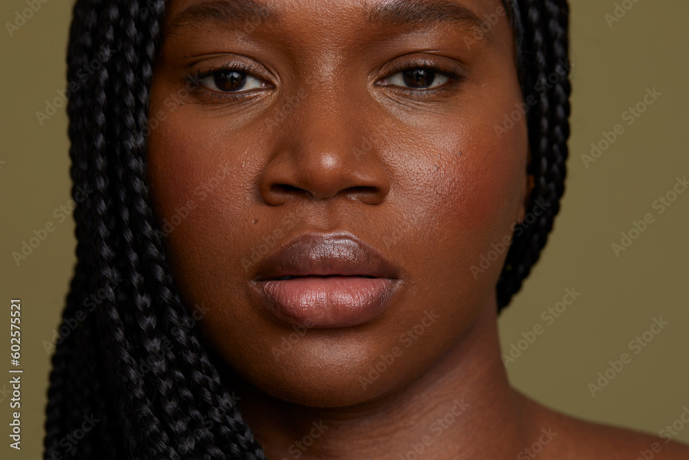 Portrait of serious woman against green background Portrait of serious woman against green background