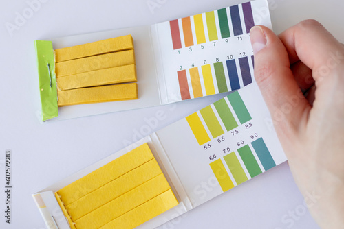 Measuring pH test strips. Two types on white background photo