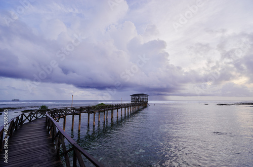 Beautiful landscape. Sunset on the seashore. Wooden bridge on Cloud Nine beach  Siargao Island Philippines.