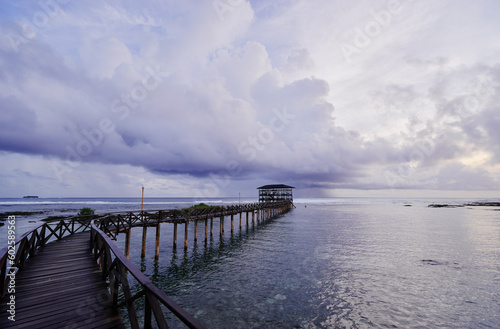 Beautiful landscape. Sunset on the seashore. Wooden bridge on Cloud Nine beach, Siargao Island Philippines.