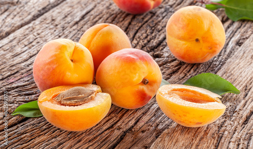 Ripe apricots on old wooden table.