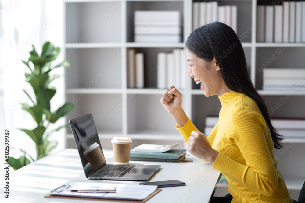 A young woman is a start-up businesswoman, she sits in the office and looks happy, manages and runs the business from the young generation. Startup business management concept.