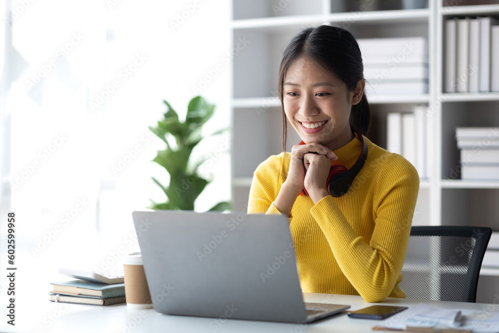 Teenage woman sitting in white room with laptop, she is a student studying online with laptop at home, university student studying online, online web education concept. Teenage woman sitting in white room with laptop, she is a student studying online with laptop at home, university student studying online, online web education concept.