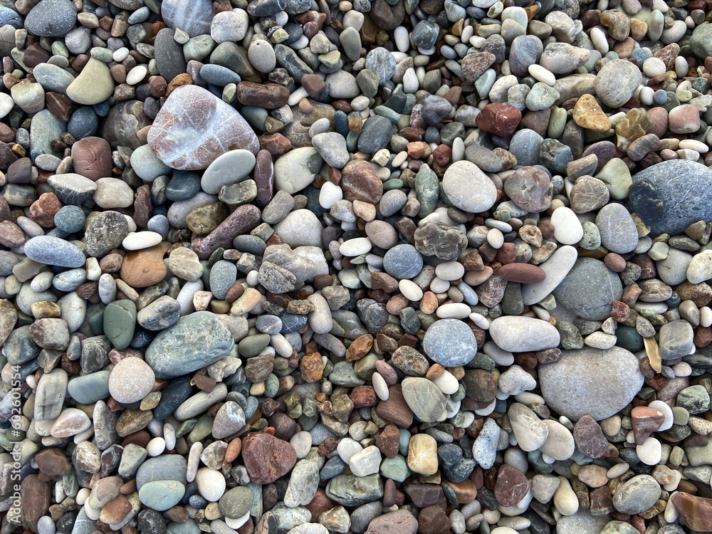 Sea stone pebble background. Multicolored abstract beach nature pattern, Small sea stones, gravel. Sea shore.