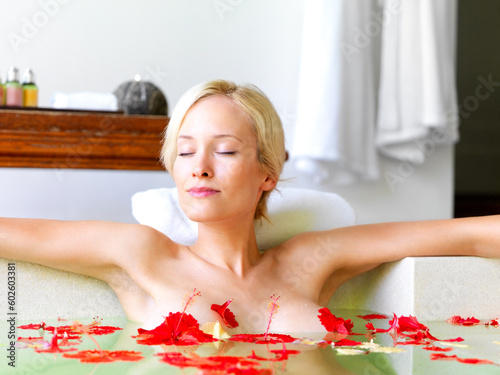 Relax, spa and flowers with woman in bath for skincare, aromatherapy or tropical vacation in Bali villa. Summer, beauty and luxury with girl in jacuzzi for spa, hotel and resort on travel destination