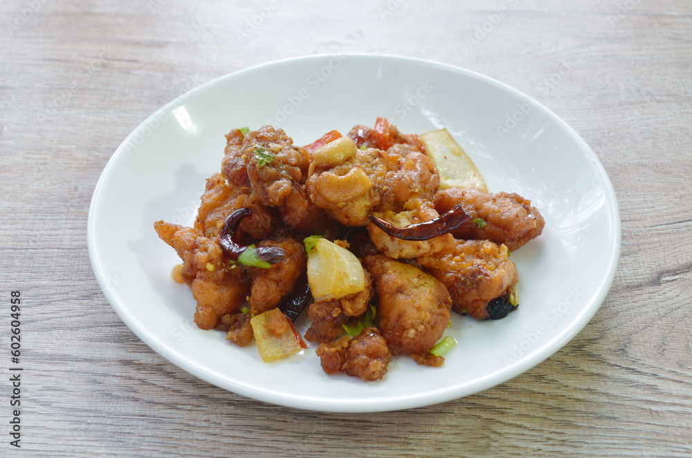 fried crispy chicken with cashew nut and slice onion on plate fried crispy chicken with cashew nut and slice onion on plate