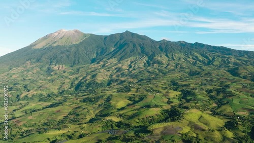 Aerial drone of farmland with plantings against a background of mountains and blue sky. Canlaon volcano. Negros, Philippines photo