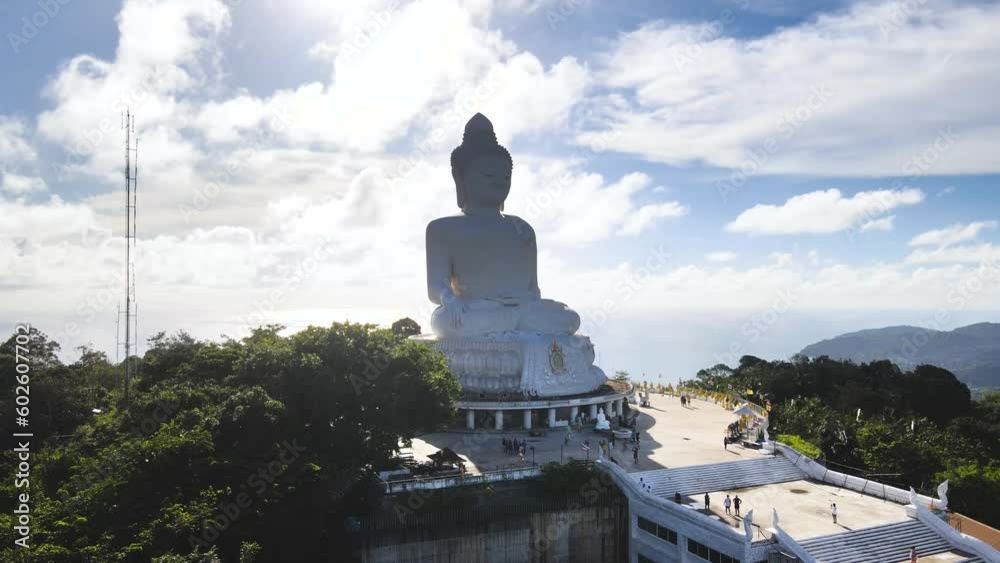 Drone video afternoon light sky and blue ocean are on the back of Phuket Big Buddha statue.white Phuket big Buddha is the one of landmarks on Phuket island Thailand. Drone video afternoon light sky and blue ocean are on the back of Phuket Big Buddha statue.white Phuket big Buddha is the one of landmarks on Phuket island Thailand.
