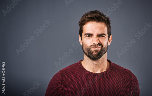Doubt, confused and portrait of man in studio with unsure, uncertain and thoughtful on gray background. Thinking, mockup space and face of male person skeptical for decision, choice and question