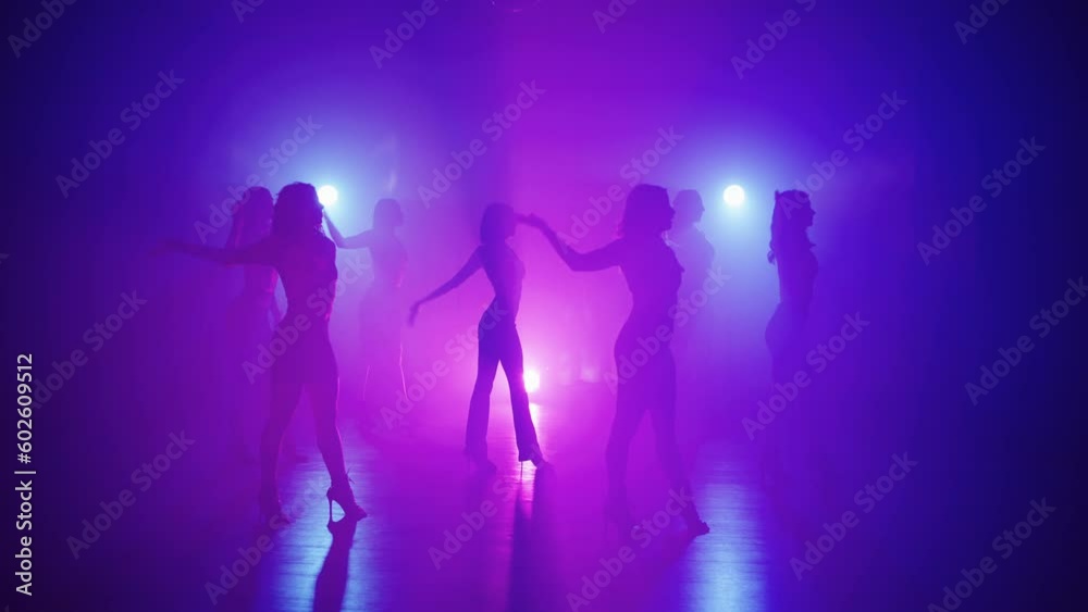 Exciting group dance on high heels in the rays of spotlights. A dance that helps to create a beautiful shape of the legs and keep them in good shape. High quality 4k footage Exciting group dance on high heels in the rays of spotlights. A dance that helps to create a beautiful shape of the legs and keep them in good shape. High quality 4k footage