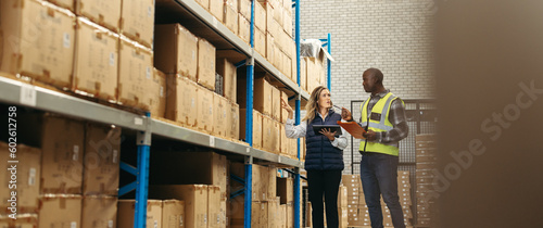 Warehouse workers recording inventory using warehousing technology photo