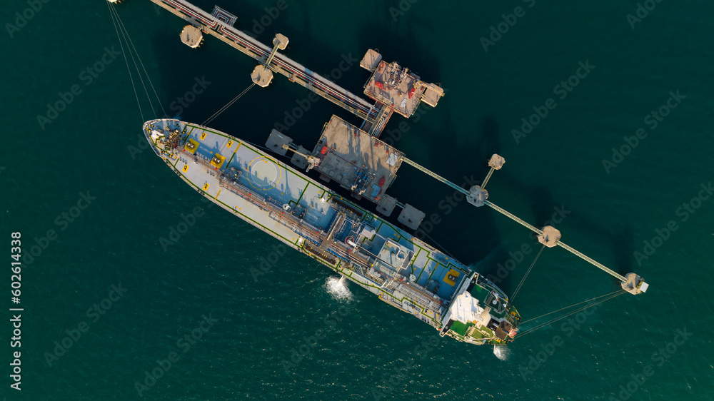 crude oil floating station in sea, bridge pipeline load unloading crude oil from oil ship transport, industry business transportation by container ship open sea, aerial drone point of view - obrazy, fototapety, plakaty 