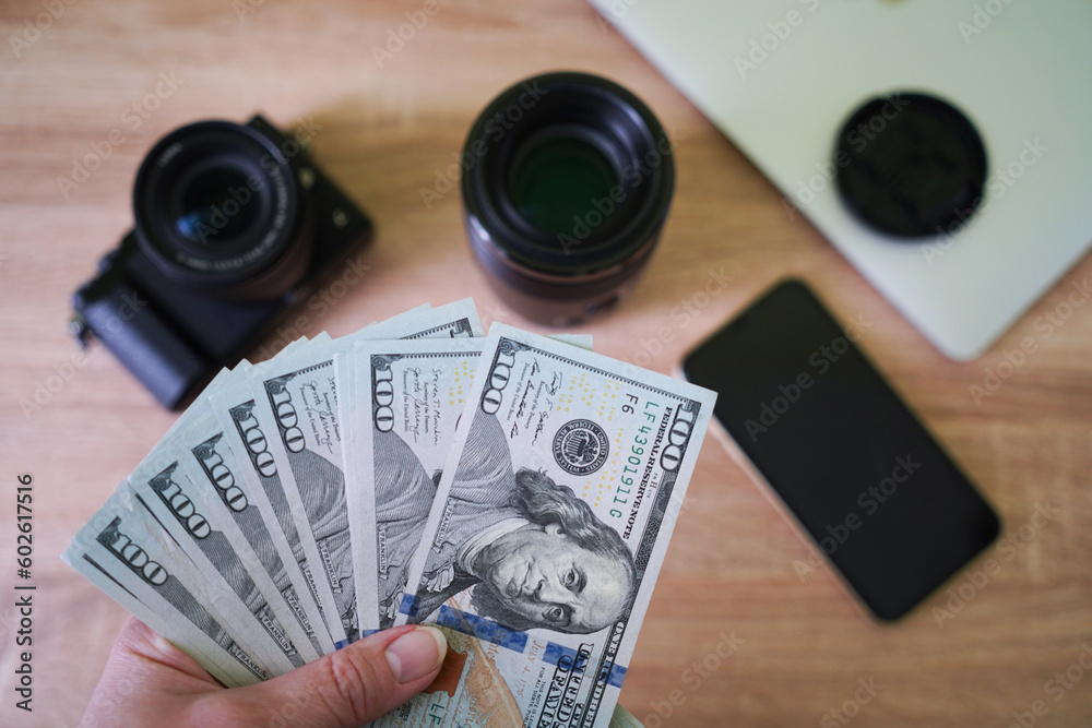 digital camera and money, store selling photographic equipment, pawnshop concept, top view,