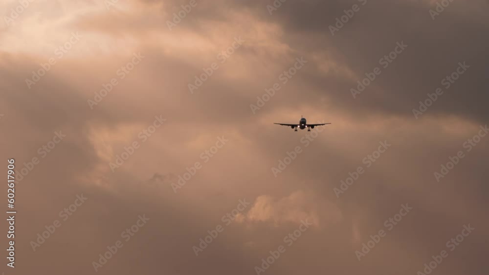 Airplane flying over spectacular sunset sky light, Passengers Jet plane in dramatic clouds. Travel and Tourism Concept Airplane flying over spectacular sunset sky light, Passengers Jet plane in dramatic clouds. Travel and Tourism Concept