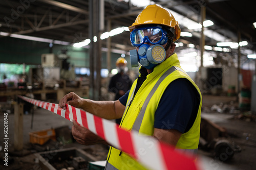 Restricted area, officials employ white and red stripes to block the area where a chemical leak is occurring. To prevent individuals from coming into contact with potentially dangerous chemicals,