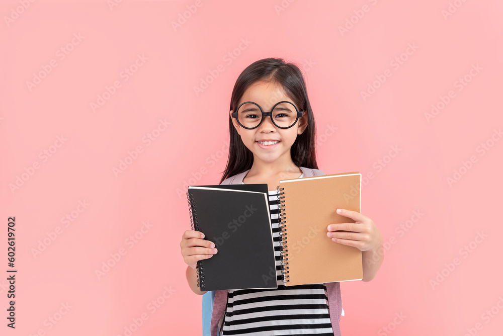 schoolgirl hugging book wearing backpack smiling isolated on pink background schoolgirl hugging book wearing backpack smiling isolated on pink background
