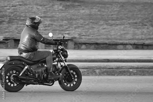 14.05.23 Montevideo, Uruguay, motorcycle on the road driving fast. having fun on the empty road on a motorcycle trip. Fast motion blur effect, white and black