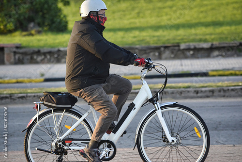 elderly man riding a bicycle, riding bicycles in the park in the late afternoon, man ride a bicycle at the nature park.