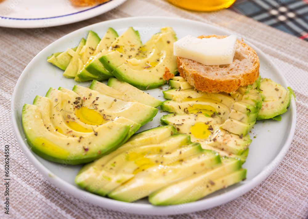 ripe avocado pulp cut into pieces sprinkled with lemon juice on a plate ripe avocado pulp cut into pieces sprinkled with lemon juice on a plate