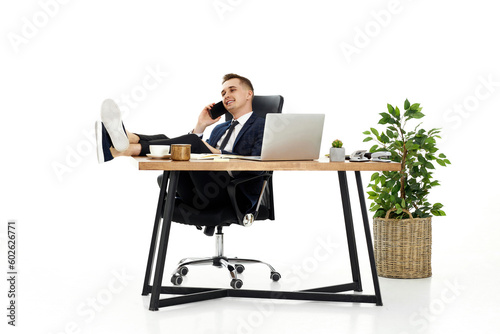 businessman working with laptop and having phone conversation with client