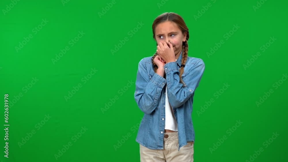 Teen girl closing nose feeling unpleasant smell turning away on green screen background. Portrait of Caucasian teenager smelling bad aroma with disgust facial expression Teen girl closing nose feeling unpleasant smell turning away on green screen background. Portrait of Caucasian teenager smelling bad aroma with disgust facial expression