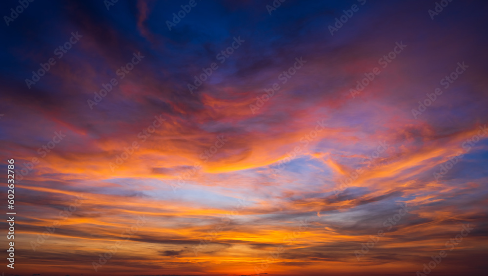 Sunset sky clouds with colorful and dramatic red, orange, yellow sunrise blue sky in the morning on night to day, Horizon skyline landscape nature background in summer