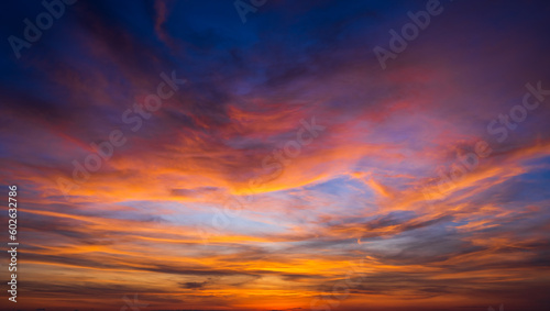 Sunset sky clouds with colorful and dramatic red, orange, yellow sunrise blue sky in the morning on night to day, Horizon skyline landscape nature background in summer © Nature Peaceful 