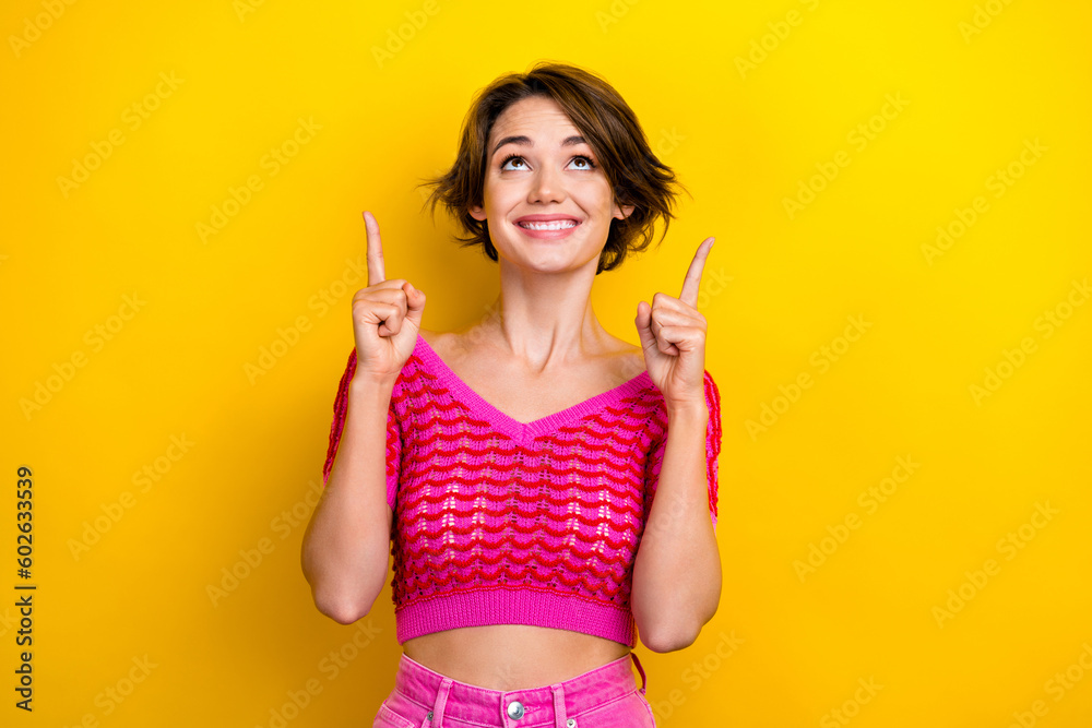 Portrait of gorgeous cheerful lady wear stylish clothes presenting empty space low price collection isolated on yellow color background Portrait of gorgeous cheerful lady wear stylish clothes presenting empty space low price collection isolated on yellow color background