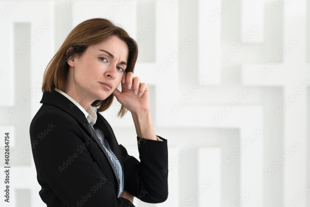 Close-up portrait of young serious business lady in black suit standing isolated on white background Close-up portrait of young serious business lady in black suit standing isolated on white background