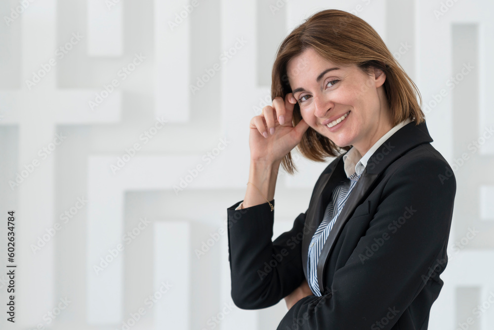 Portrait of attractive and smiling business woman standing in the office Portrait of attractive and smiling business woman standing in the office