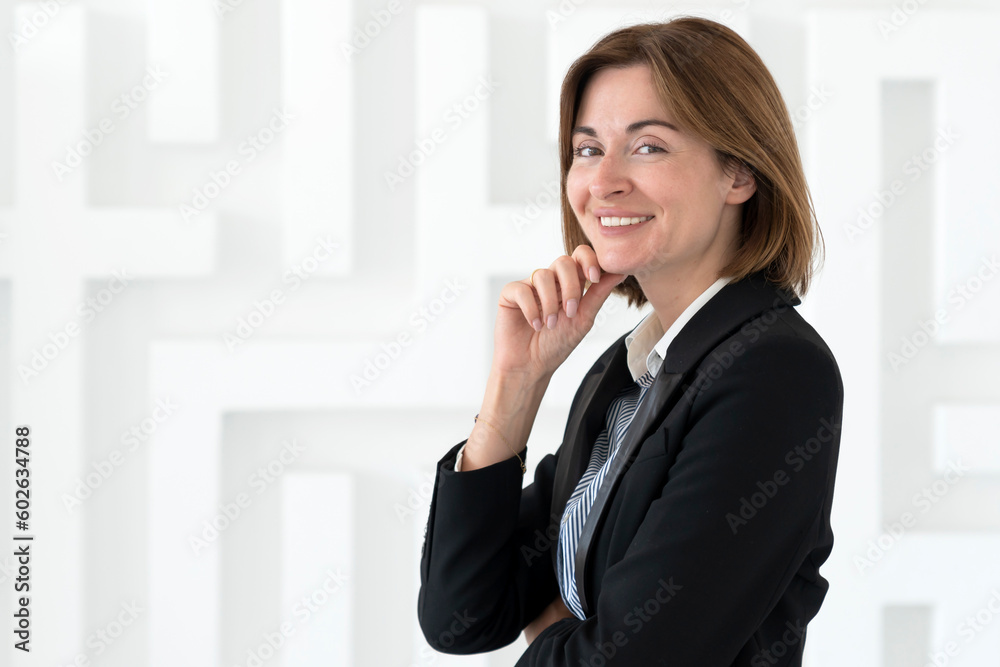 Portrait of attractive and smiling business woman standing in the office Portrait of attractive and smiling business woman standing in the office