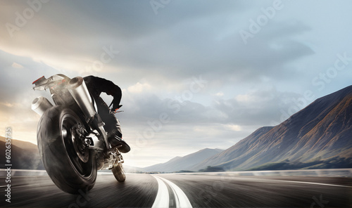 Tablou canvas Back bottom view image of man, professional motorbike rider on road, riding with high speed around mountains