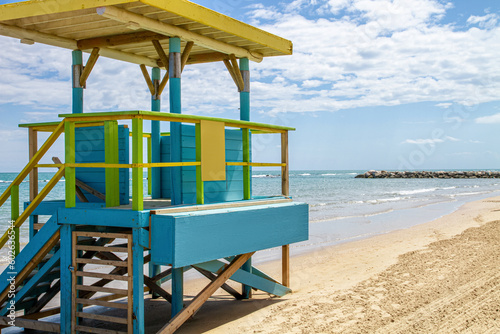 A beautiful beach with a colorful lifeguard booth © MM